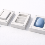 A printed report with charts and graphs lies on a desk, framed by blue key tags, a pencil, binder clips, and rolled papers.