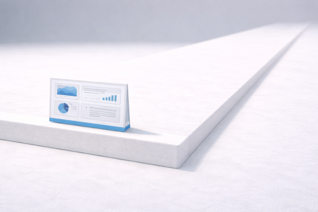 A small dashboard-style display sits on the edge of a large white platform, emphasizing scale and minimalism.