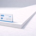 A small dashboard-style display sits on the edge of a large white platform, emphasizing scale and minimalism.