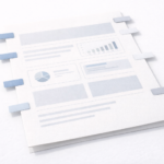A minimalist illustration of a document layout with charts and text sections, marked by blue tabs along the edges to indicate organized sections or revisions.